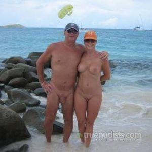 A nude couple having fun in the water outdoors