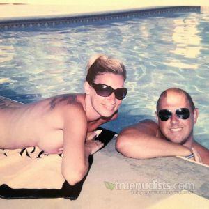 Solo nudist couple with cool tattoos outside